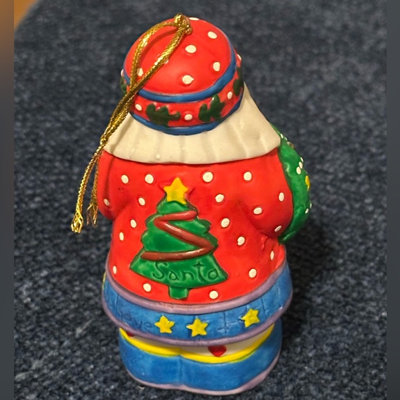 Brightly colored ceramic Santa ornament. Santa carries a tree & wreath. - Picture 5 of 10